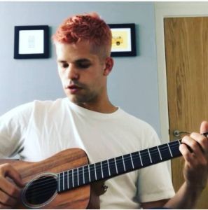 Photo of Max Carver with his Guitar.
